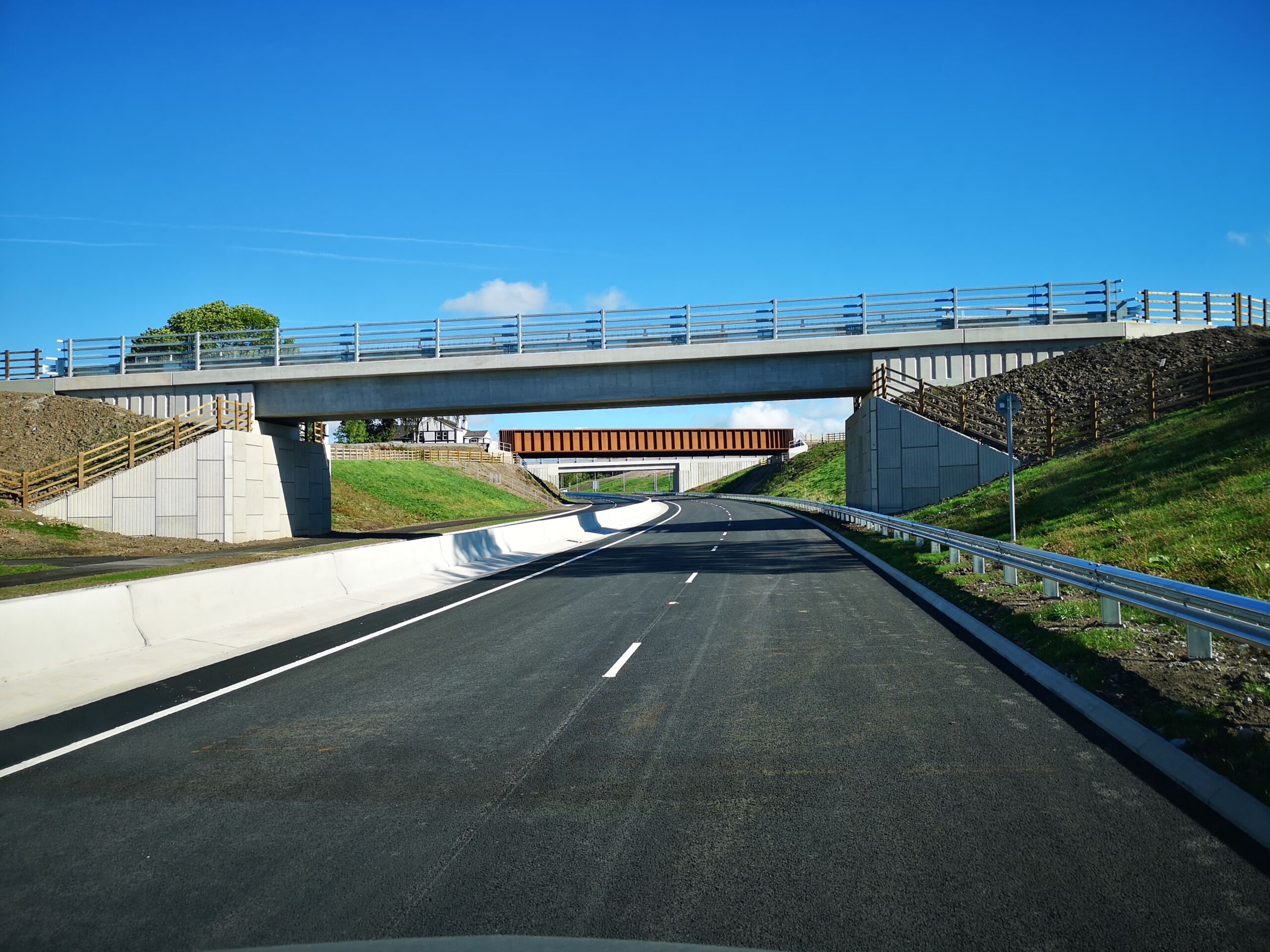 Manchester Airport Relief Road – Geoquest Bridge and Highway Infrastructure Newly constructed section of the Manchester Airport Relief Road with overbridges, reinforced earth embankments and safety barriers